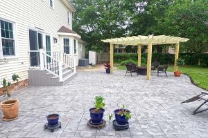 Outdoor Living Area with stamped concrete patio and custom pergola in Virginia Beach
