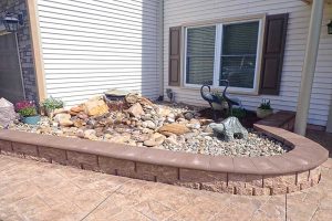 Landscaping bed with a water feature and stone