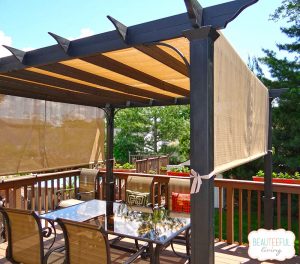 Deck pergolas with curtains add privacy to area